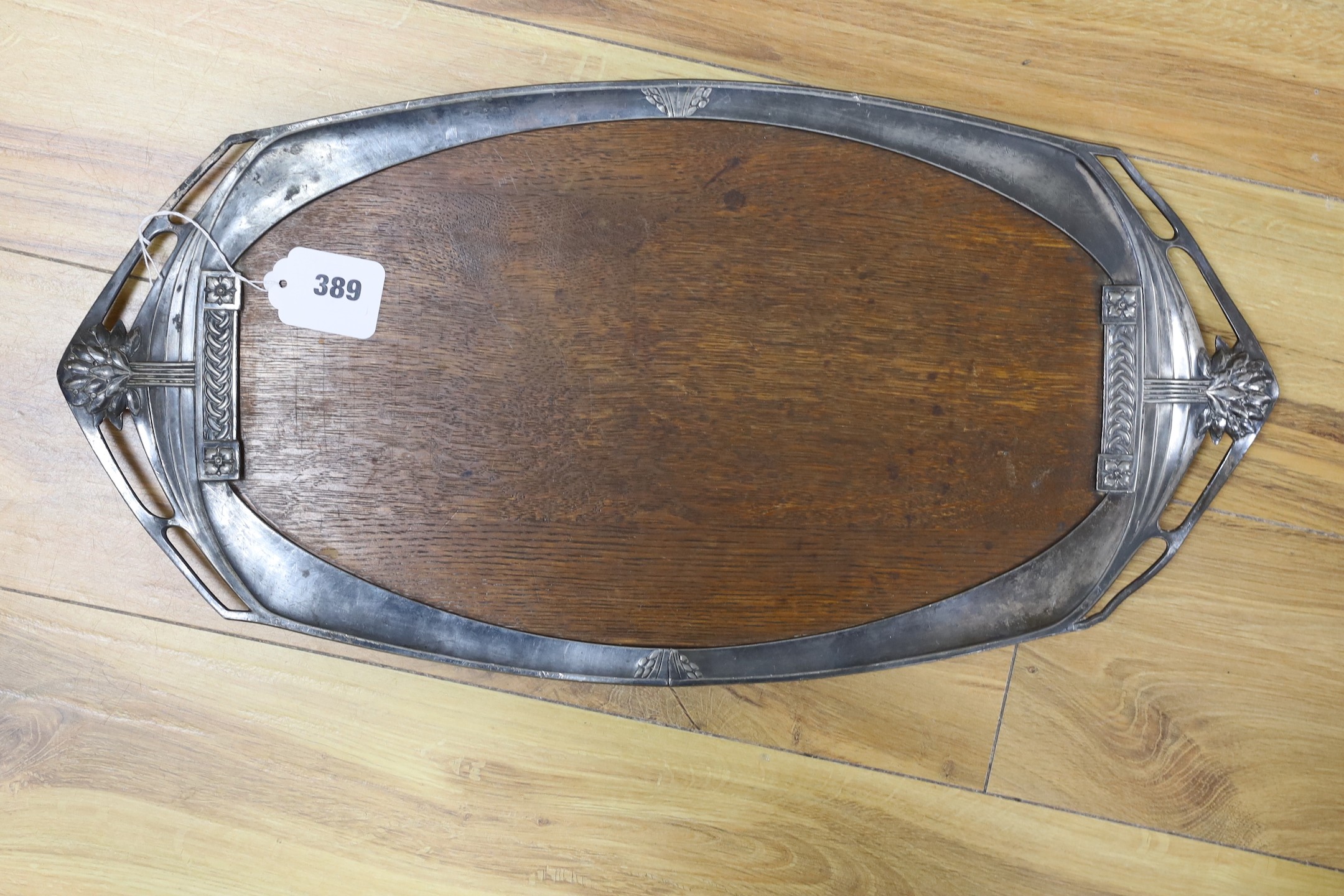 An Edwardian oval Art Nouveau metal tray, a similar oak and pewter tray and a WMF box, pewter tray 58 cms wide.